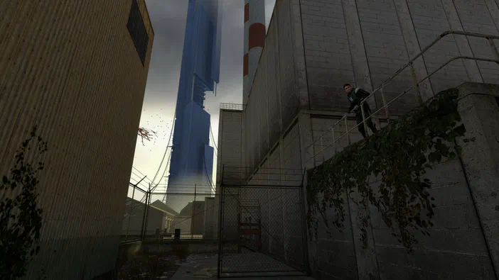 Capture d'écran de Half-Life 2 montrant un personnage grimpan sur une structure métallique dans un environnement industriel sombre avec des bâtiments et une tour en arrière-plan.