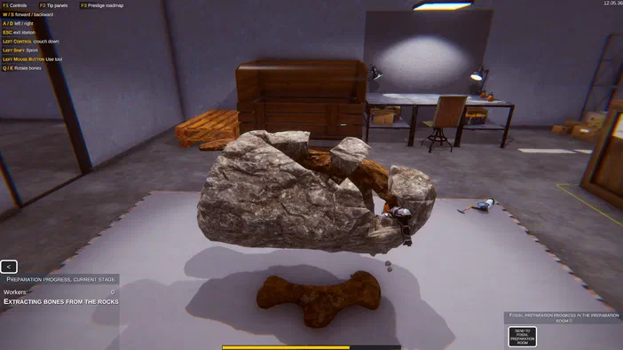Dans le jeu Dinosaur Fossil Hunter, une vue en perspective montre un os de dinosaure extrait d'un bloc rocheux dans une salle de préparation.
