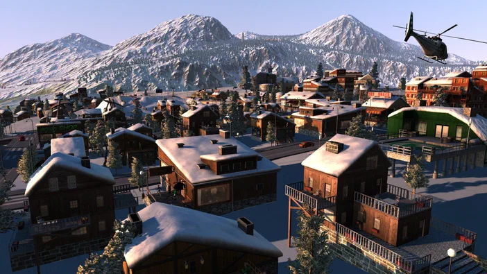 Vue aérienne d'une ville de montagne enneigée dans le jeu Cities XL Platinum avec un hélicoptère au-dessus.