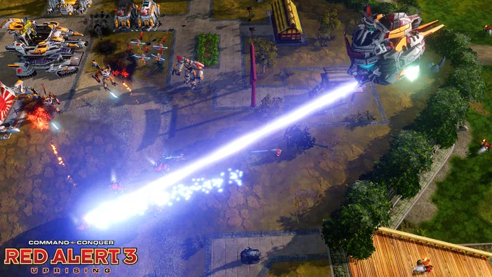 Capture de jeu vidéo Command & Conquer Red Alert 3 Uprising montrant une base avec des véhicules et un rayon laser bleu intense.
