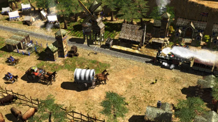 Capture de jeu vidéo Age of Empires III montrant un village colonial avec des chariots tirés par des chevaux et une locomotive à vapeur sur les rails.