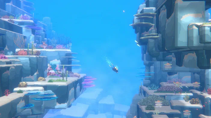 Capture d'écran du jeu Dave the Diver montrant un personnage plongeant dans une grotte sous-marine aux parois rocheuses et corallines colorées.