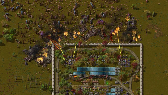 Vue aérienne d'une base industrielle en expansion dans le jeu Factorio, avec des usines bleues et des explosions à l'extérieur.