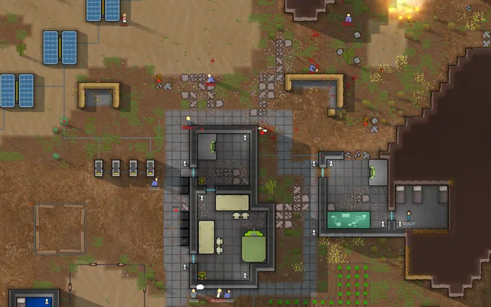Vue de dessus d'une base coloniale dans le jeu RimWorld avec des bâtiments et du matériel scientifique sur un terrain désertique.