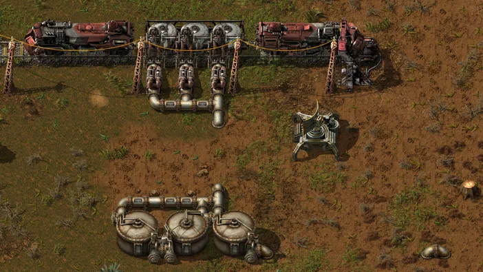 Capture d'écran du jeu Factorio montrant une base industrielle avec des trains et des convoyeurs sur un terrain en terre.