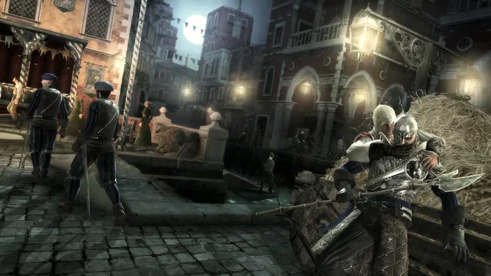 Capture d'écran du jeu Assassin's Creed II montrant un personnage en armure tenant une arme dans une rue pavée de Venise la nuit.