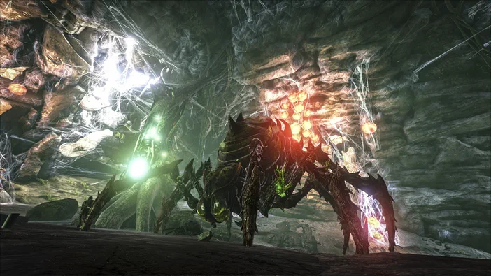 Capture d'écran du jeu vidéo ARK: Survival Evolved montrant deux dinosaures dans une grotte sombre avec des effets lumineux.