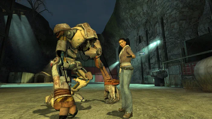 Dans Half-Life 2, Alyx Vance se tient à côté d'un robot de combat en position genouillée dans un environnement industriel sombre.