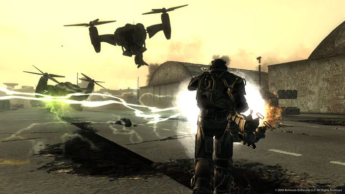 Capture d'écran du jeu Fallout 3 montrant un personnage en armure tirant sur des hélicoptères dans une base aéroportuaire.
