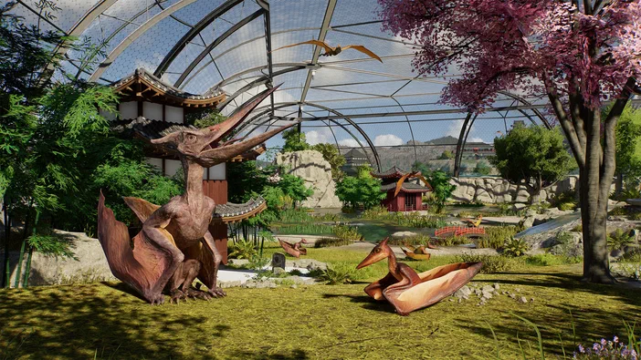 Capture d'écran de Jurassic World Evolution 3 montrant un parc avec des ptérosaures dans une structure en verre.