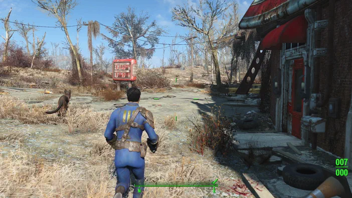 Capture d'écran du jeu Fallout 4 montrant un personnage en armure bleue courant dans une zone post-apocalyptique avec des arbres dépouillés et un bâtiment endommagé.