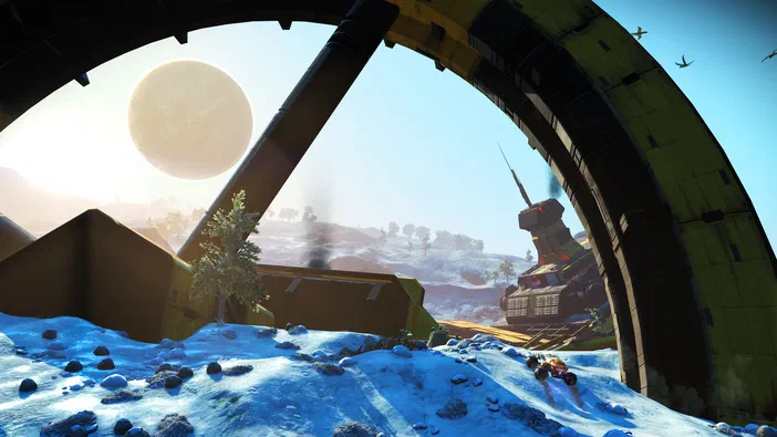 Capture d'écran du jeu vidéo No Man's Sky montrant un paysage extraterrestre enneigé avec une structure géante et des vaisseaux spatiaux au loin.